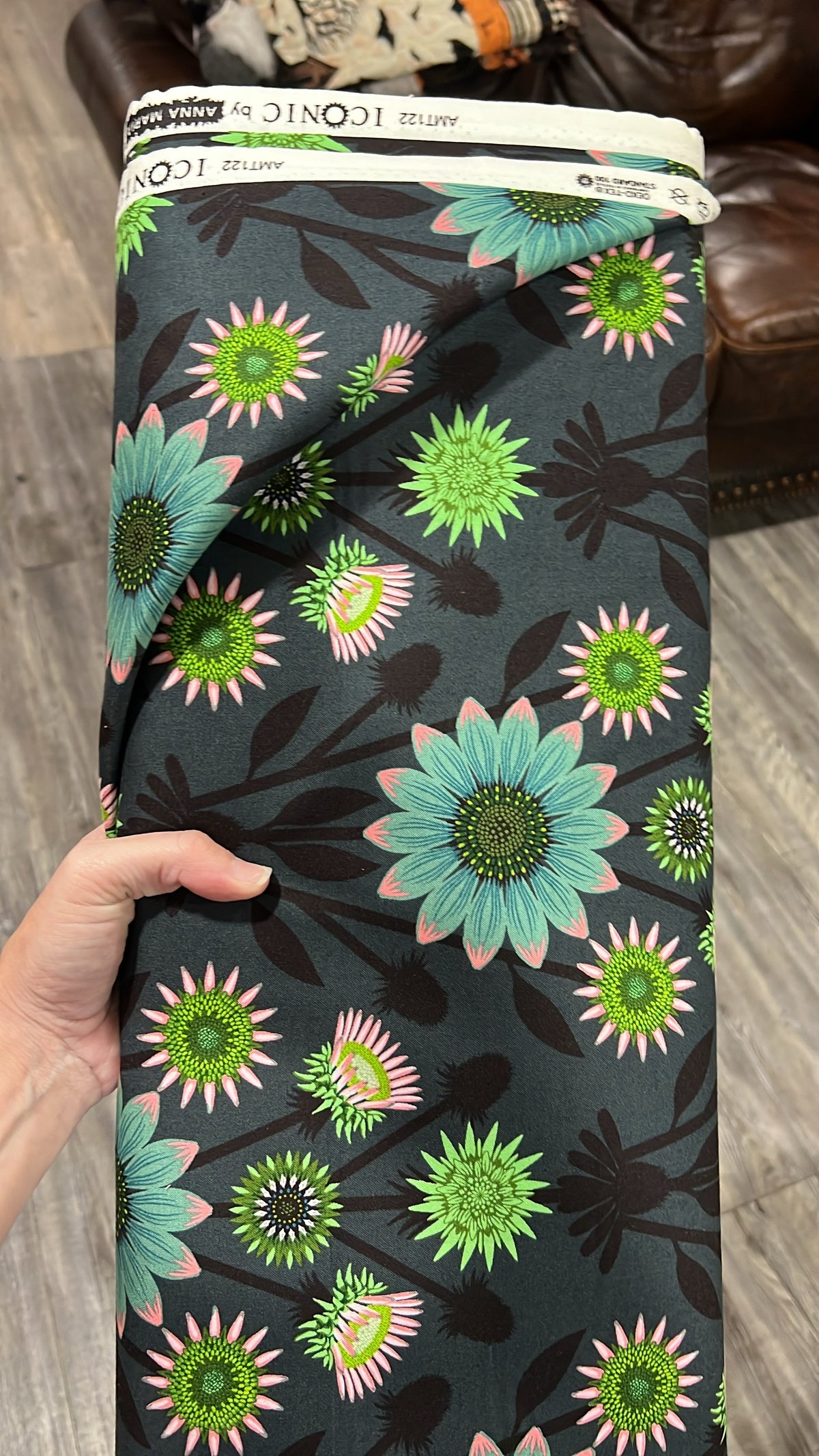 Lifespan in Patina fabric by Anna Maria for Northcott, folded to show the coneflower print texture on a dark patina ground