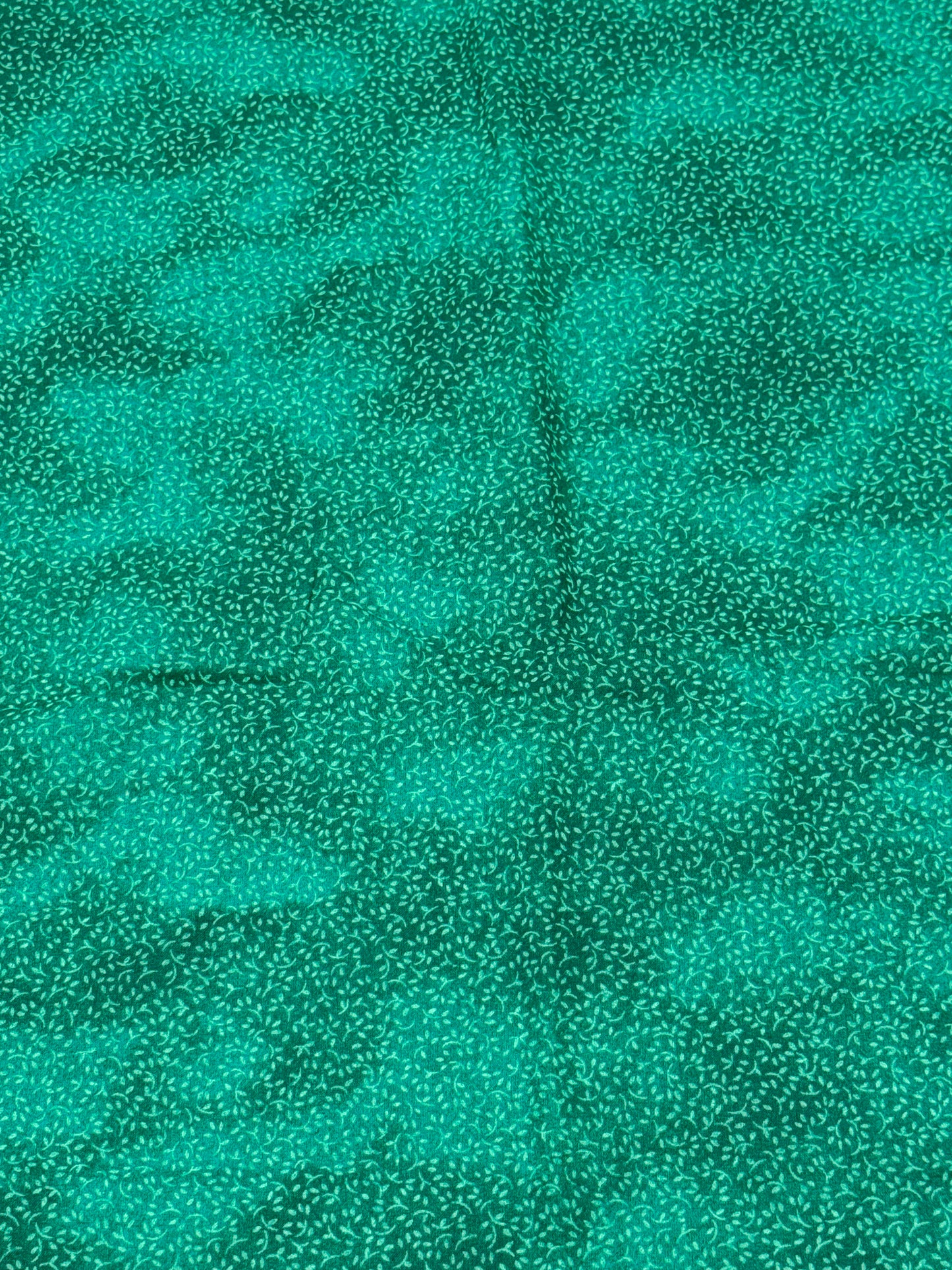 Bluish green fabric with design