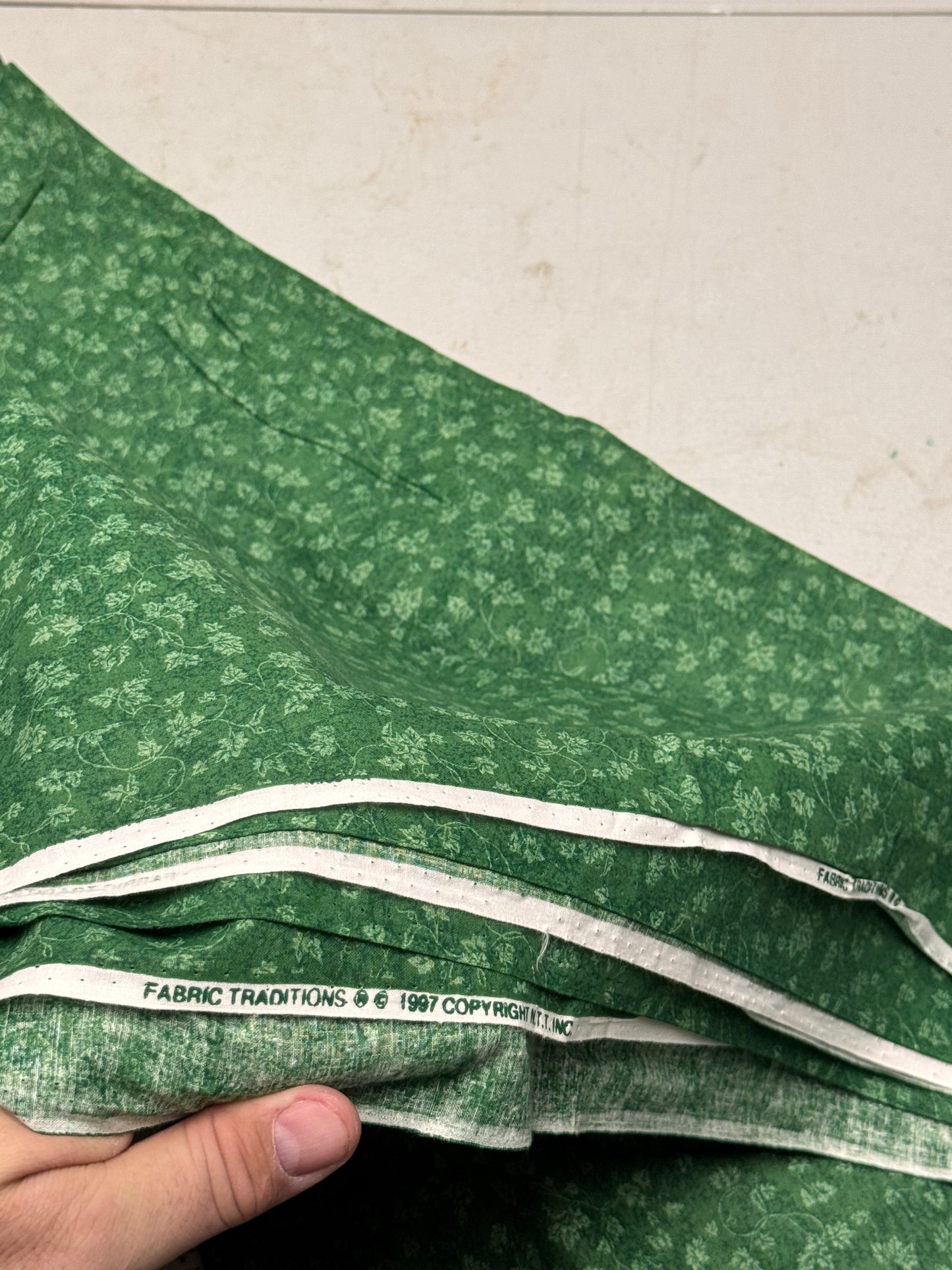 FABRIC TRADITIONS greenish fabric with leaves on a vine