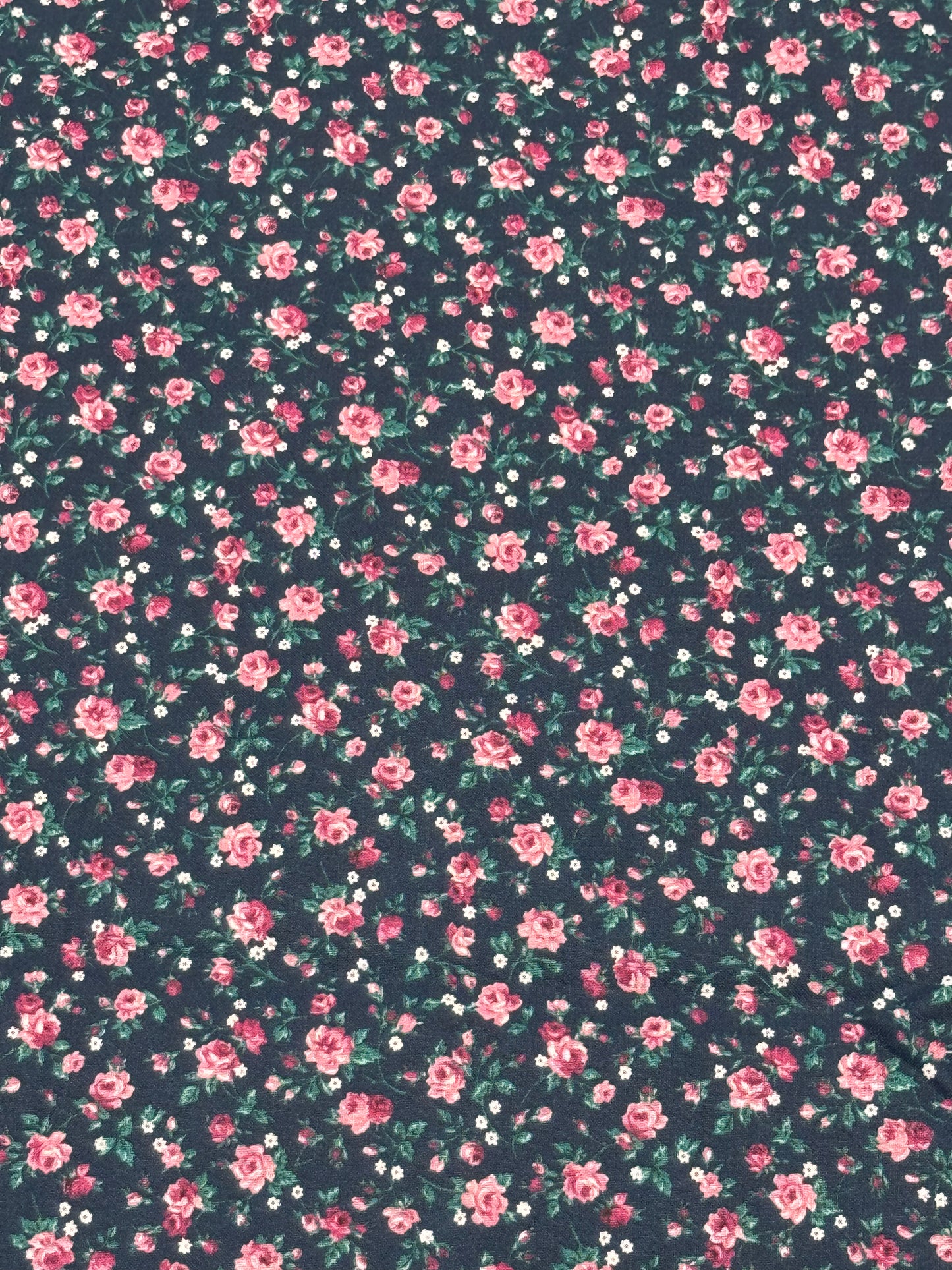 Bluish fabric with small roses and white flowers on stem