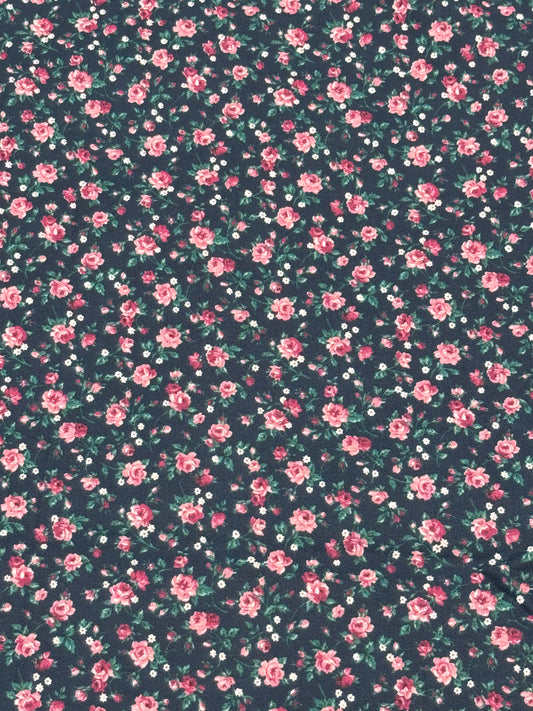 Bluish fabric with small roses and white flowers on stem